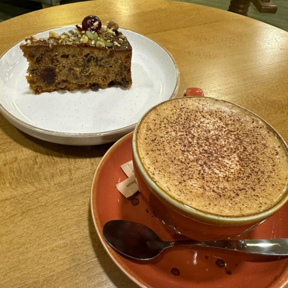 Slice of cake and a cup of coffee on a wooden table